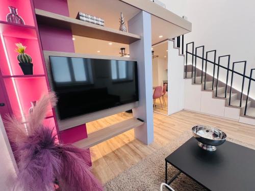 a living room with a large flat screen tv on a wall at Zeus Design Loft Apartments Braunhirschen in Vienna