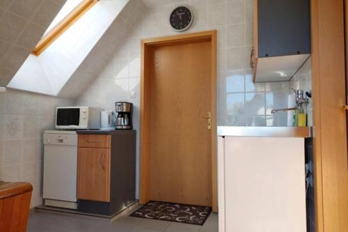 a kitchen with a sink and a door in a room at NEU Ferienwohnung Storchennest OG in Kramerhof