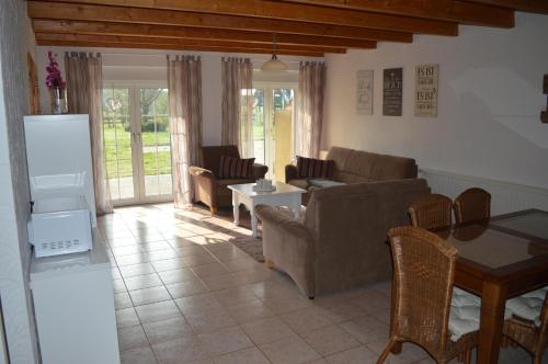 a living room with a couch and a table at NEU! Hennings Ferienhof in Neßmeraltendeich