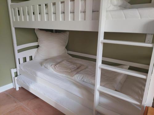 a white bunk bed in a room at NEU! Ferienwohnung Böhlitz Neun in Grimma