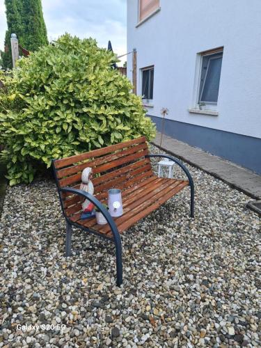 a wooden bench with a stuffed animal sitting on it at NEU! Ferienwohnung Eulennest in Staudernheim