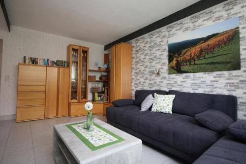 a living room with a couch and a table at NEU! 3 Sterne Ferienwohnung Loreley DTV Klassifizierung in Bornich