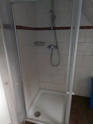a bathroom with a shower with a white tub at Ferienhaus Doris Seeblick in Tannenhausen
