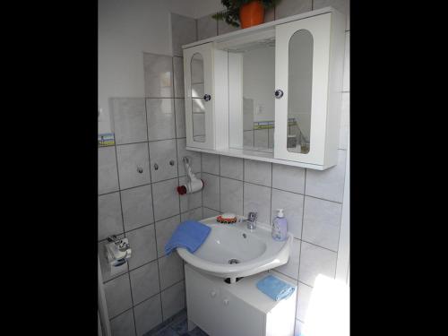 a white bathroom with a sink and a mirror at NEU! FeWo Sankt Florian nähe Heide, SPO, Büsum in Lehe