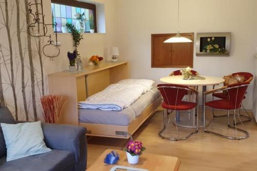 a room with a bed and a table and chairs at NEU! Ferienwohnung Ramke EG in Lilienthal