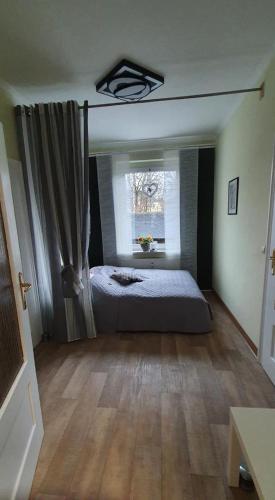 a bedroom with a bed and a window at NEU! Ferienwohnung Unger in Schwarzenberg