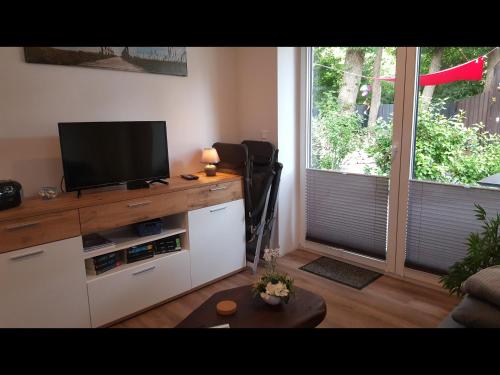 a living room with a flat screen tv on a counter at NEU! Ferienwohnung Amrum in Taarstedt