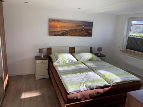 uma cama num quarto com uma fotografia na parede em NEU! Ferienwohnung MOIN em Langwedel