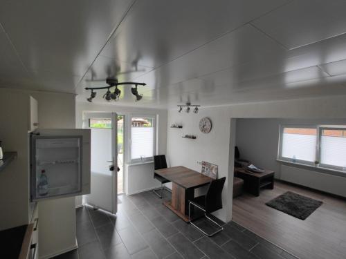 a living room with a table and a tv at NEU Ferienwohnung Wildgans Dollart Ostfriesland in Bunde