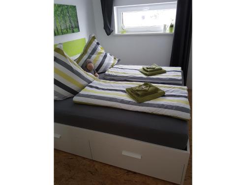 two beds in a small room with a child sleeping on them at NEU Apartment am Birkenfeld Allgäu Kaufbeuren in Steinholz