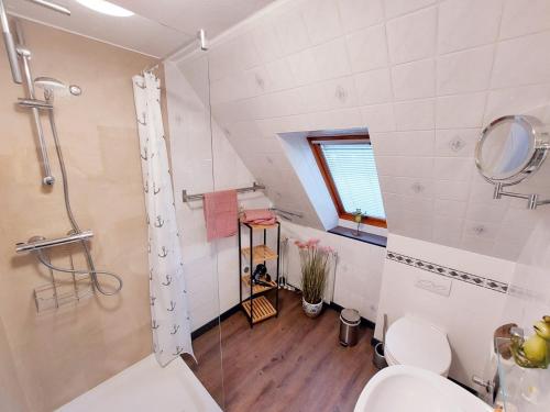 a bathroom with a shower and a toilet and a sink at NEU! Nordseedomizil Langenhorn in Langenhorn