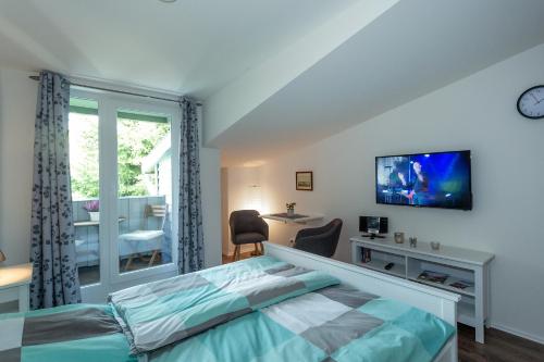 a bedroom with a bed and a tv on a wall at NEU! Appartement Zur Heidschnucke in Toppenstedt