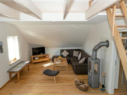 a living room with a couch and a fireplace at Ferienwohnung Meer und Muh in Strenglin