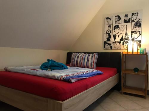 a bedroom with a bed with a red blanket at NEU Ferienhaus mit Poolhalle und Sauna in Pyrbaum