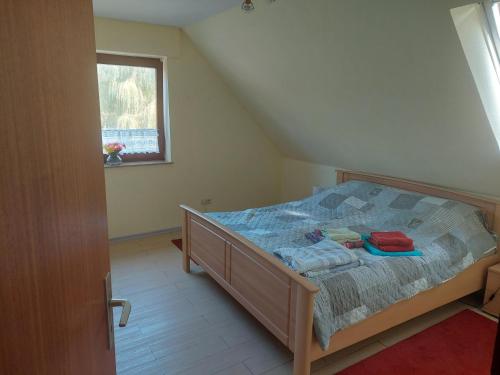 a small bedroom with a bed in a attic at NEU! Nordsee-Ferienwohnung Nicki in Dornum