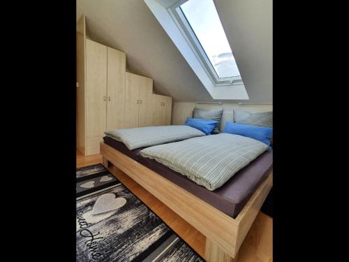a bedroom with a large bed with a skylight at NEU Elizahaus-Ringbergblick Suhl in Suhl