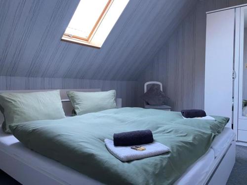 a bedroom with a large bed with two towels on it at NEU! FeWo am alten Deich mit Balkon in Osteel