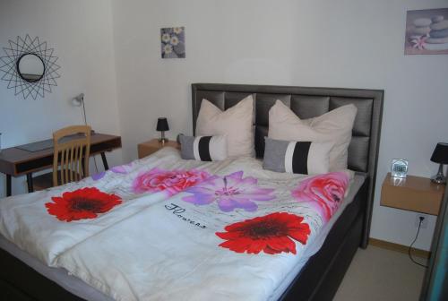 a bedroom with a bed with flowers on it at NEU! Schönes Urlaubsdomizil an der Nordsee in Stedesdorf