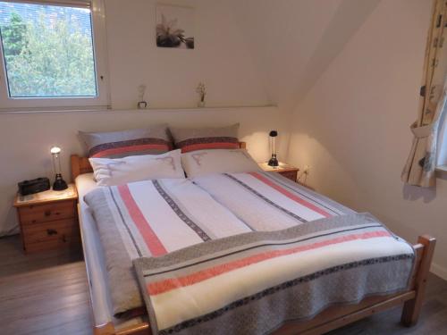 a bedroom with a large bed in a attic at NEU Ferienwohnung Wellenrauschen in Westerholt