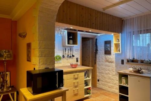 a kitchen with a sink and a counter with a tv at Ferienwohnung Le Paradis in Bad Ems