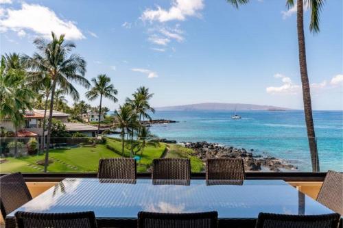 a table with chairs and a view of the ocean at MAKENA SURF, #G-301-302 condo in Wailea