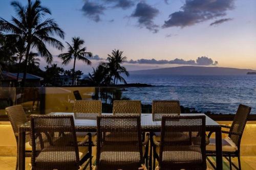 a table and chairs with a view of the ocean at MAKENA SURF, #G-301-302 condo in Wailea