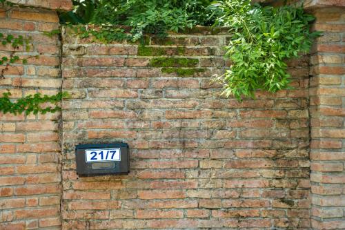 a brick wall with a clock on it at 悬崖别墅 无边海景 直达海滩 五卧泰式独栋私人泳池别墅 超漂亮日出 in Phuket Town