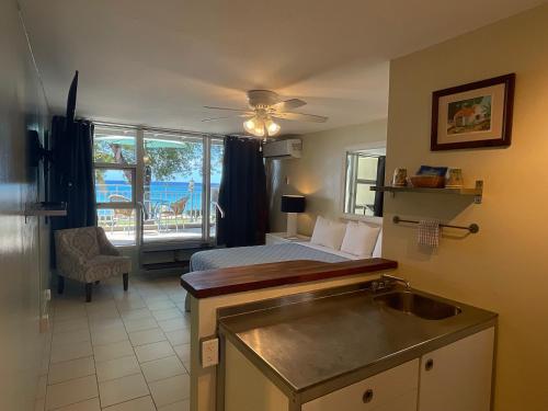 a bedroom with a bed and a kitchen with a sink at The Frederiksted Hotel in Frederiksted