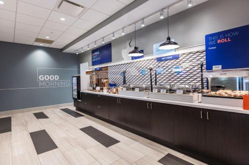 a fast food restaurant with a counter with food at Holiday Inn Express & Suites - Welland in Welland