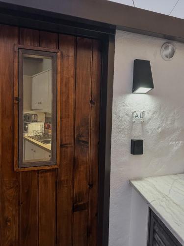 a wooden door in a kitchen with a light at Estúdio em Alte - KARMEA HOUSES in Alte