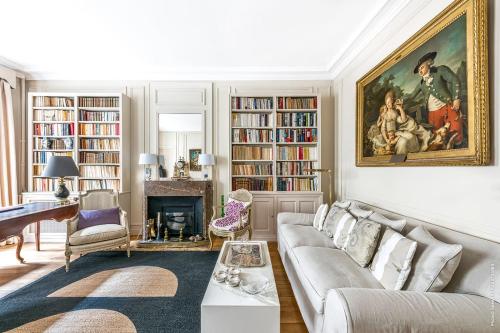 a living room with a couch and a fireplace at Gros Caillou - Grenelle 2bdr in Paris