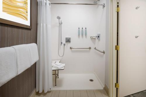 a bathroom with a shower with a shower curtain at Courtyard by Marriott Palmdale in Palmdale