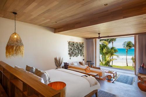 a bedroom with a bed and a view of the ocean at W Punta de Mita in Punta Mita