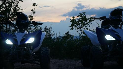 two atvs parked on a dirt road at sunset at PISCINA SARITA CLUB BOUTIQUE in Girardot