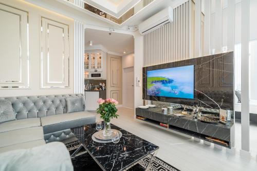 a living room with a couch and a tv at Q18 ApartHotel in Bydgoszcz