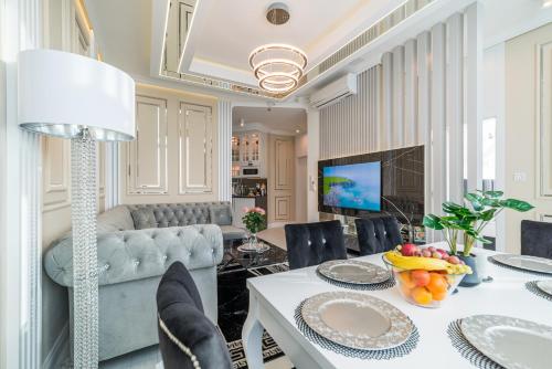 a living room with a table and a couch at Q18 ApartHotel in Bydgoszcz