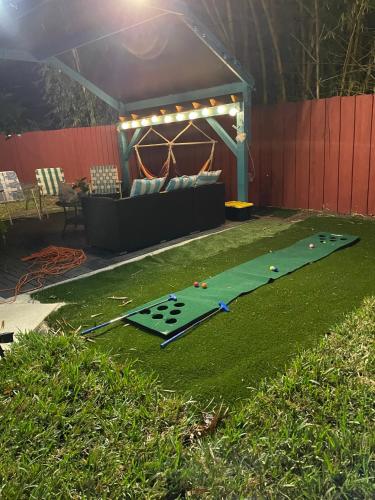 a miniature golf course in a yard with a couch at Backyard Oasis in Port Saint Lucie