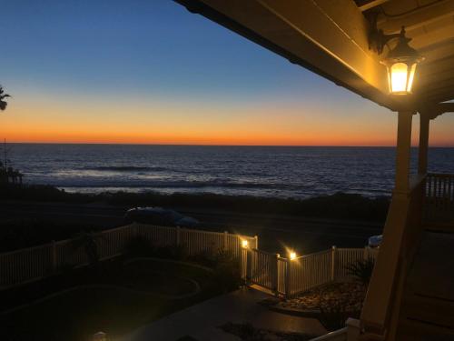a view of the ocean at sunset from a house at Casa De La Playa in San Diego