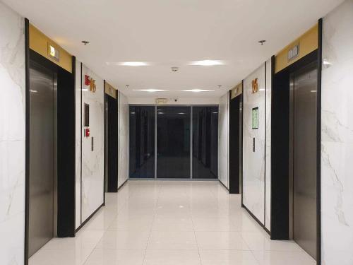 a hallway of a building with elevators at HOMESNAP CONDOTEL FAME RESIDENCE MANDALUYONG in Manila