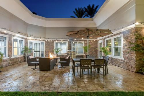 an outdoor patio with a table and chairs at Residence Inn by Marriott Corona Riverside in Corona