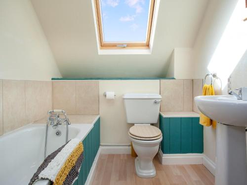 a bathroom with a toilet and a sink at Uk45541-old Stable Cottage in Sticklepath