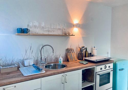 a kitchen with a sink and a wooden counter top at Seebrise Ferienwohnung, Auszeit in ruhiger Lage, Bodensee Nähe, Privatparkplatz, Wlan, Smart TV in Rielasingen-Worblingen