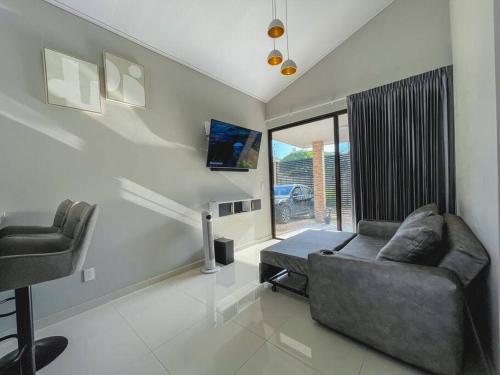 a living room with a couch and a chair at Fortu House in Carrillo