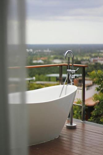 a bath tub sitting on top of a balcony at Sky View Luxury Pool Villa - SHA in Surat Thani