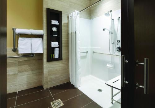 a bathroom with a shower and a sink and a toilet at AeroStay in Sioux Falls
