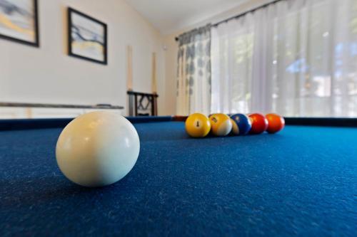 a pool table with a cue ball and balls on it at Ultimate Vacation: A Luxurious Oasis with a Pool! in Las Vegas