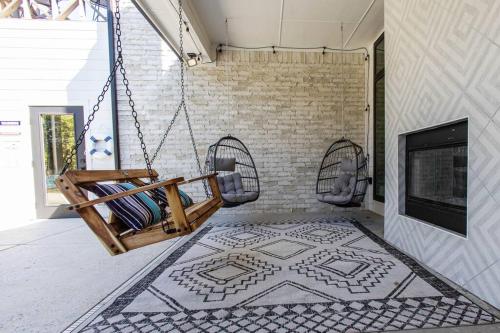 a porch with a swing and a fireplace at Tiger Mansion-Paradise with Pool in Waxahachie