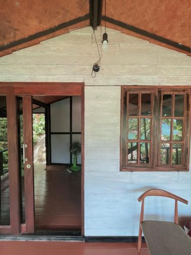 an open door of a house with windows at Silver cliff room 3 in Than Sadet Beach