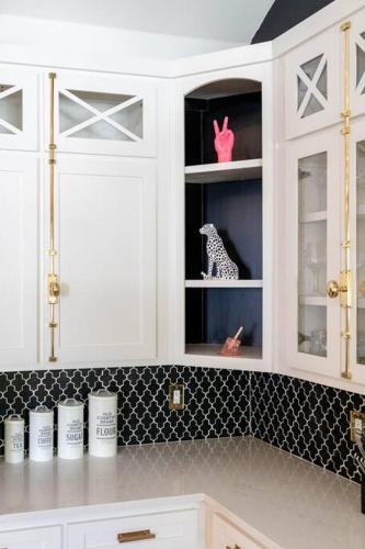 a kitchen with white cabinets with a toy dog in it at Tiger Mansion-Paradise with Pool in Waxahachie