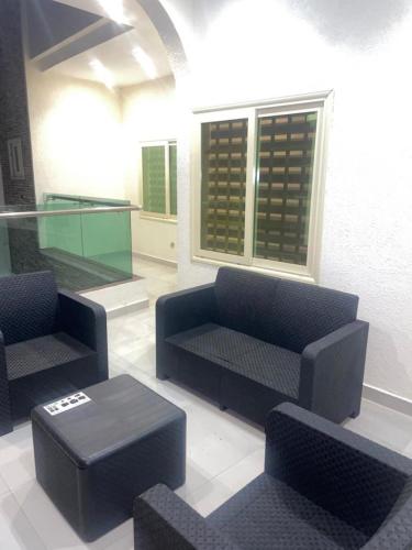 a living room with two couches and a table at RESIDENCE MH SERVICES Cotonou in Cotonou